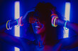 © kohanova1991 - Cyberpunk style portrait of glamorous african woman on party under glowing colorful light. Nightclub, futuristic costume and neon glasses. Teenager, zoomer Z-generation.