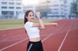 © EduLife Photos - A young beautiful Asian woman in sports outfits doing stretching before workout outdoor in the park in the morning to get a healthy lifestyle. Healthy young woman warming up outdoors