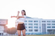 © EduLife Photos - A young beautiful Asian woman in sports outfits doing stretching before workout outdoor in the park in the morning to get a healthy lifestyle. Healthy young woman warming up outdoors