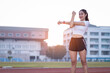 © EduLife Photos - A young beautiful Asian woman in sports outfits doing stretching before workout outdoor in the park in the morning to get a healthy lifestyle. Healthy young woman warming up outdoors