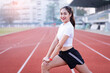 © EduLife Photos - A young beautiful Asian woman in sports outfits doing stretching before workout outdoor in the park in the morning to get a healthy lifestyle. Healthy young woman warming up outdoors