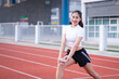 © EduLife Photos - A young beautiful Asian woman in sports outfits doing stretching before workout outdoor in the park in the morning to get a healthy lifestyle. Healthy young woman warming up outdoors