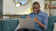 © stockbakers - Angry Young African Man Feeling Disappointed on Laptop
