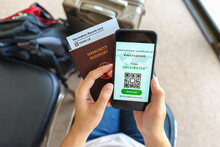 Disease Immunity Passport, Tourist Uses Of Application On Smartphone To Show An International Certification Of Vaccination At Airport With Immunity Passport And Vaccination Record Card For Covid-19