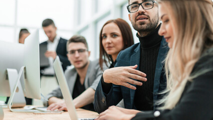 Poster - close up. employees work on laptops in a modern office