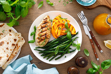 Canvas Print - Grilled chicken breast with green beans and butternut squash, top view