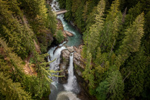 Aerial View Of Nooksack Falls Seen In The Cascade Mountains Of Washington State. The Water Flows Through A Narrow Valley And Drops Freely 88 Feet Into A Deep Rocky River Canyon. 
