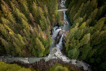 Aerial View Of Nooksack Falls Seen In The Cascade Mountains Of Washington State. The Water Flows Through A Narrow Valley And Drops Freely 88 Feet Into A Deep Rocky River Canyon. 