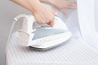 © Владислав Легір - Steam blue iron on ironing board. Clothes, ironing board household concept
