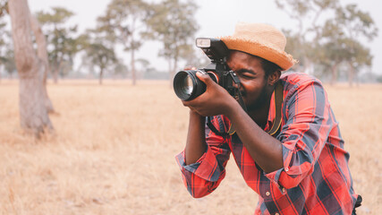 Wall Mural - African Traveler man or photographers standing and traveling in the savannah fields