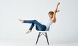 © SHOTPRIME STUDIO - pretty woman in jeans stands on a chair fashion glamor isolated background