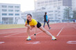 © EduLife Photos - A young beautiful Asian woman in sports outfits doing stretching before workout outdoor in the city stadium  in the morning to get a healthy lifestyle. Healthy young woman doing excercise