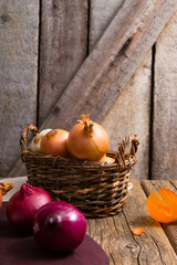 Wall Mural - onions and garlics on cutting board, weathered wooden background