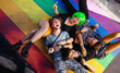 Four young queer people lying down together