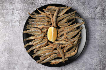 Wall Mural - Portion of fried anchovies (Andalusian frying)