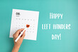 Text happy left handers day and calendar with heart in 13th of august over blue background