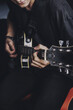 © Антон Фрунзе - a guy in a dark T-shirt plays an electric guitar on a dark background