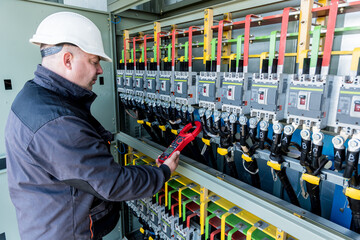 Wall Mural - checking the operating voltage levels of the solar panel switchgear compartment