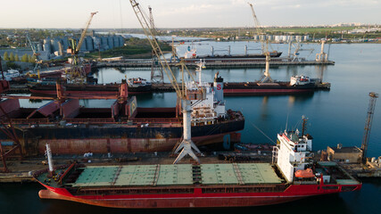 Wall Mural - Industrial port in the field of import-export global business logistics and transportation, Loading and unloading container ships, cargo transportation from a bird's eye view.