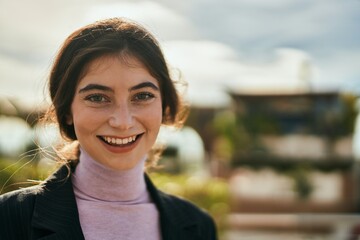 Poster - Young beautiful businesswoman smiling happy standing at the city.