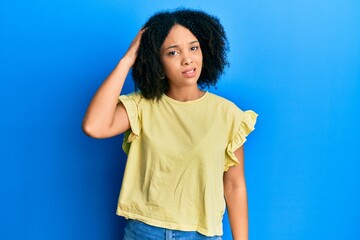 Poster - Young african american girl wearing casual clothes confuse and wonder about question. uncertain with doubt, thinking with hand on head. pensive concept.