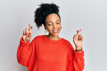 Sticker - Young african american girl wearing casual clothes gesturing finger crossed smiling with hope and eyes closed. luck and superstitious concept.