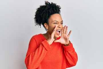 Sticker - Young african american girl wearing casual clothes shouting angry out loud with hands over mouth