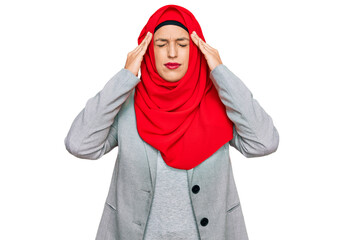 Poster - Beautiful hispanic woman wearing traditional islamic hijab scarf suffering from headache desperate and stressed because pain and migraine. hands on head.