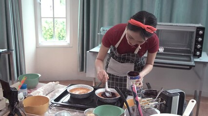 Wall Mural - Young Asian woman cooking food. Bakery in kitchen at home. Enjoying hobby making homemade bread. Small cooking class business.