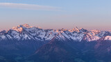 Fototapeta Góry - Snowy mountain range during sunrise