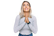 © Krakenimages.com - Beautiful blonde woman wearing casual clothes begging and praying with hands together with hope expression on face very emotional and worried. begging.