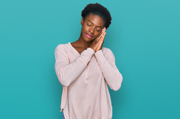 Sticker - Young african american girl wearing casual clothes sleeping tired dreaming and posing with hands together while smiling with closed eyes.