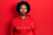 © Krakenimages.com - Young african american woman wearing casual sweatshirt relaxed with serious expression on face. simple and natural looking at the camera.
