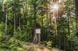 © Annabell Gsödl - A raised hide of a hunter in the forest at sundown