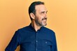 © Krakenimages.com - Middle age hispanic man wearing casual clothes looking to side, relax profile pose with natural face and confident smile.