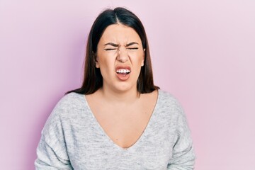 Poster - Young hispanic woman wearing casual clothes with hand on stomach because indigestion, painful illness feeling unwell. ache concept.