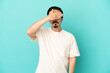 © luismolinero - Young caucasian man isolated on blue background covering eyes by hands. Do not want to see something