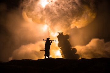 Military soldier silhouette with bazooka. War Concept. Military silhouettes fighting scene on war fog sky background, Soldier Silhouette aiming to the target at night.