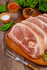 Wall Mural - Sliced raw pork shoulder with skin on wooden surface.