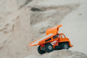 Truck in a sand quarry. Large excavator loads rock with iron or bauxite mining dump truck in a quarry against the sky