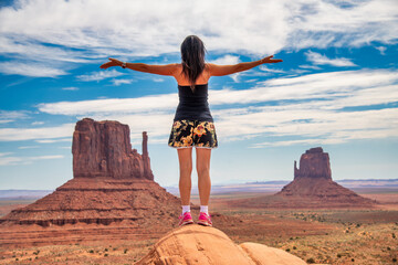 Sticker - Back view of a beautiful woman embracing wonderful Monument Valley scenario.