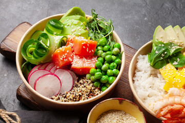 Wall Mural - Poke bowls with shrimps, salmon, avocado and mango