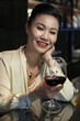 © DragonImages - Smiling pretty woman resting in restaurant on Friday night and enjoying drinking glass of red wine