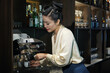 © DragonImages - Female restaurant manager making cup of coffee to ged more energy for the rest on the night