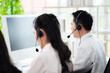 © SEVENNINE_79 - Team of call center staff in Asia wears headphones with a microphone. Smile while serving customers at desks and computers. Service concept and consulting. Communication concept.