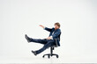 © SHOTPRIME STUDIO - Cheerful business man in a suit is rolling in an office manager chair