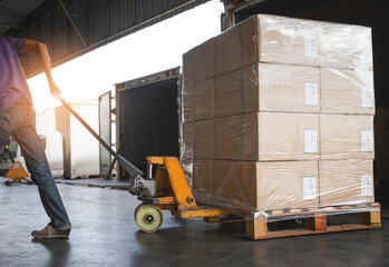 Worker Unloading Package Box Out of The Inside Cargo Container. Delivery Service. Shipping Warehouse Logistics and Transport.