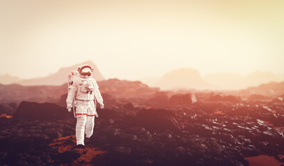 Wall Mural - astronaut doing space walk and explore planet such as mars.