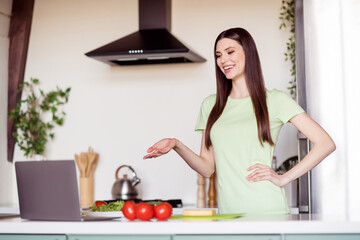 Sticker - Photo of pretty funny young lady wear green t-shirt smiling cutting tomatoes talking modern device indoors room home house