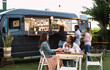 © Alessandro Biascioli - Happy multiracial people having fun eating in a street food truck
